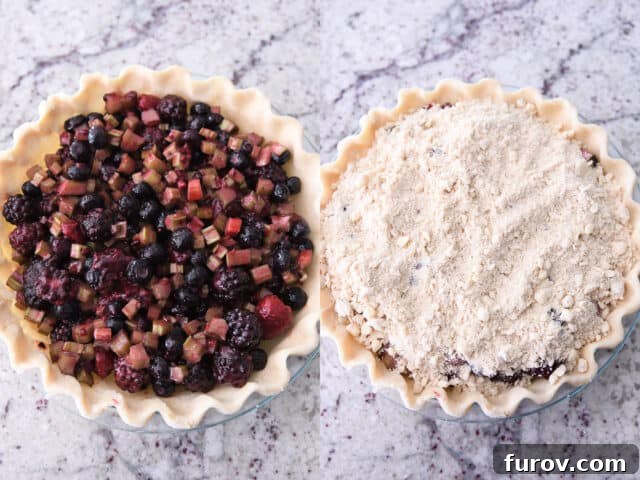 An unbaked pie with a perfectly flaky crust filled with the vibrant berry rhubarb mixture, topped with a generous layer of streusel crumbs.