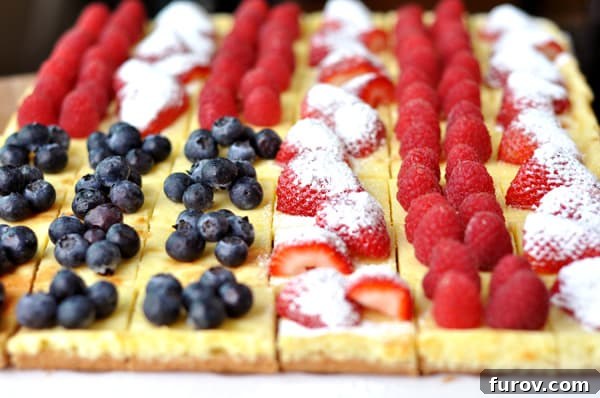 Cheesecake squares decorated with berries to look like an American flag.