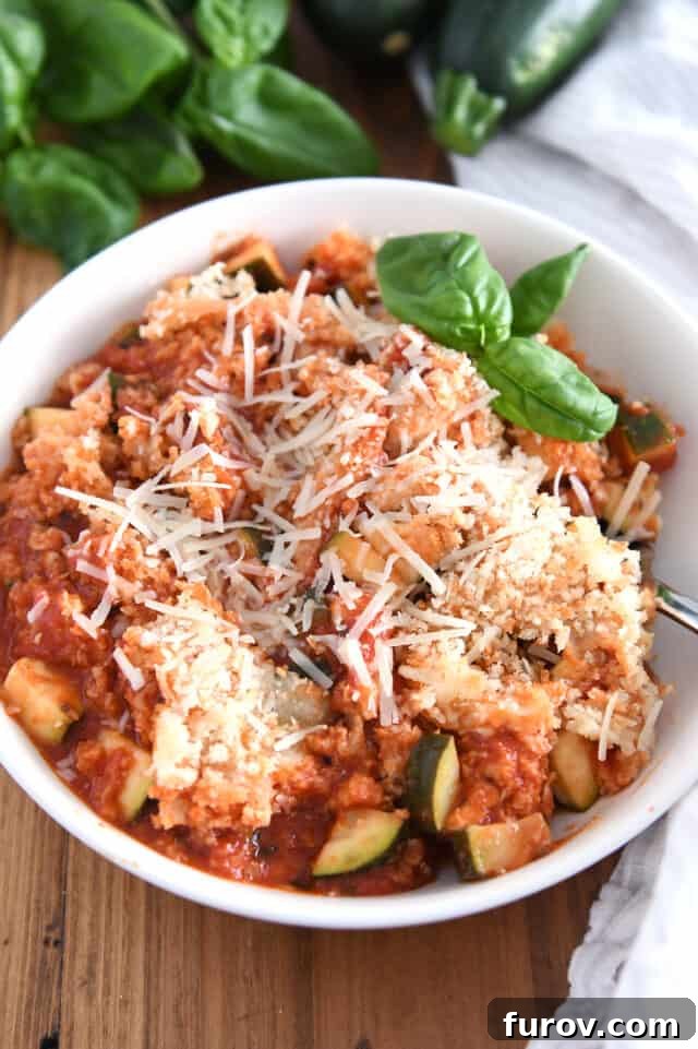 Sizzling Skillet Chicken Zucchini with Italian Cheeses 2 Serving of Italian chicken zucchini skillet meal in white bowl, garnished with fresh basil.
