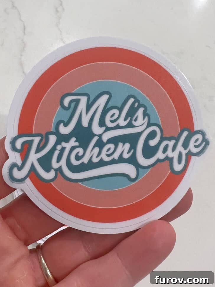 A close-up of a charming Mel's Kitchen Cafe sticker, symbolizing the brand.