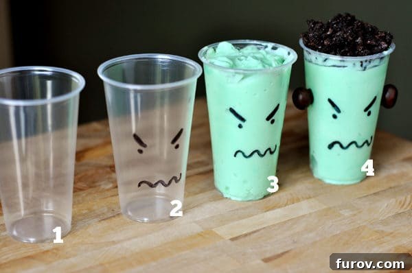 A step-by-step visual guide showing four clear plastic cups. The first cup is empty with a drawn monster face. The second is filled with green pudding. The third has crushed cookies on top. The fourth is a finished monster pudding cup with M&M eyes.