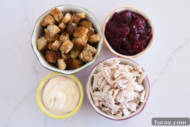 The Ultimate Leftover Turkey Sandwich: Restaurant Favorite At Home 3 Bowl with stuffing, bowl with cranberry sauce, bowl with mayonnaise, and bowl with shredded turkey.