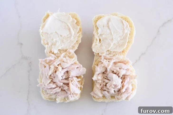 The Ultimate Leftover Turkey Sandwich: Restaurant Favorite At Home 5 Two rolls open, spread with mayo, and shredded turkey on bottom half.