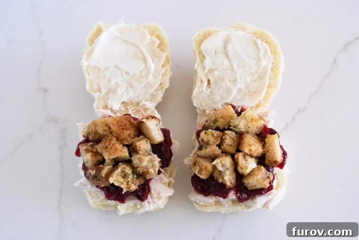 The Ultimate Leftover Turkey Sandwich: Restaurant Favorite At Home 7 Two rolls open, spread with mayo, and layered with shredded turkey, cranberry sauce and stuffing.