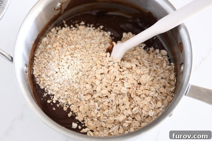 Irresistible No-Bake Chocolate Cookies 6 Quick oats and old-fashioned rolled oats being folded into the chocolate no-bake cookie batter.