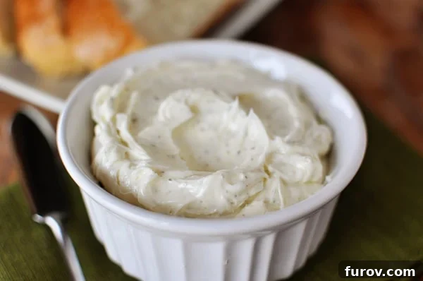 Zesty Garlic and Herb Butter 2 Small white dish with garlic herb butter spread, ready to be served on fresh bread.