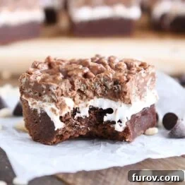 A square killer crunch brownie with all three layers visible.