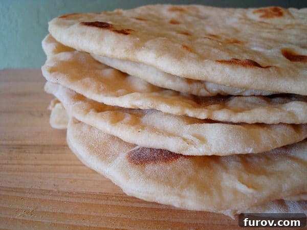 Stack of golden soft wrap bread on a table, highlighting its inviting texture.