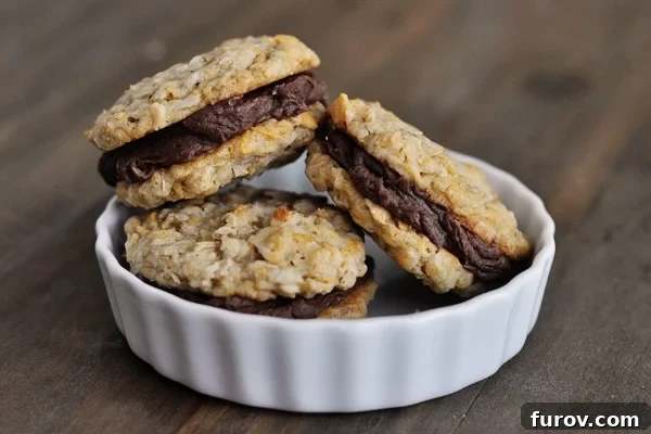 A small white ramekin filled with three fudge filled cookies, showing the soft, chewy interior.