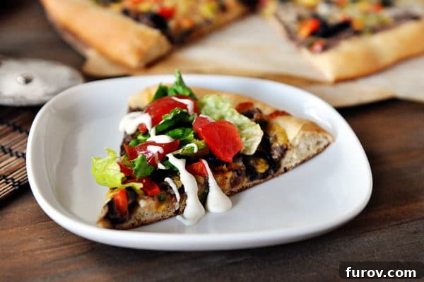 A slice of black bean taco pizza on a white plate.
