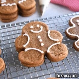 several decorated gingerbread people cookies on wire rack