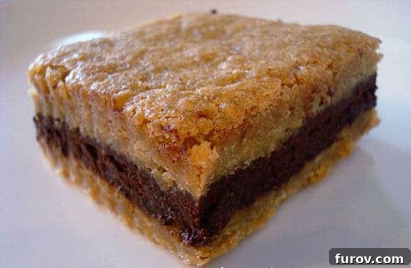 A perfectly portioned dark chocolate ganache brown sugar bar on a white plate, showcasing its distinct layers and inviting texture.