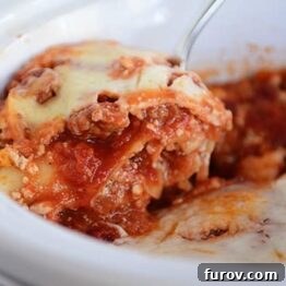 A close-up shot of a slow cooker lasagna slice, with steam rising and melted cheese visible, enticing hungry diners.