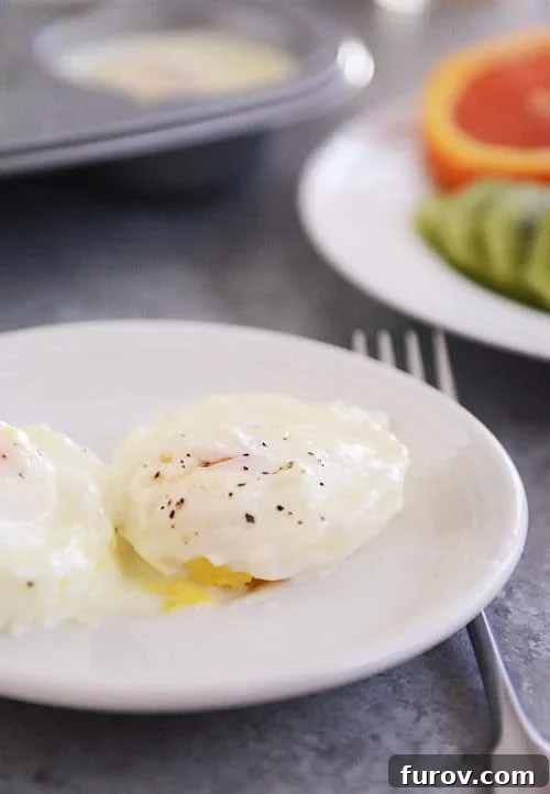Christmas Morning Baked Eggs and Festive Menu Ideas 2 A beautifully cooked, creamy baked egg, delicately sprinkled with pepper, served on a pristine white plate.