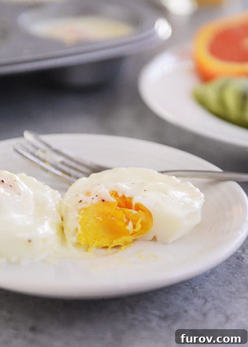 Christmas Morning Baked Eggs and Festive Menu Ideas 3 A white plate showcasing a perfectly cooked baked egg with a single bite taken out, revealing its creamy interior.