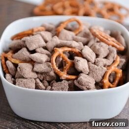 Fudgy Brownie Batter Buddies 5 A close-up shot of decadent brownie batter puppy chow with pretzels.