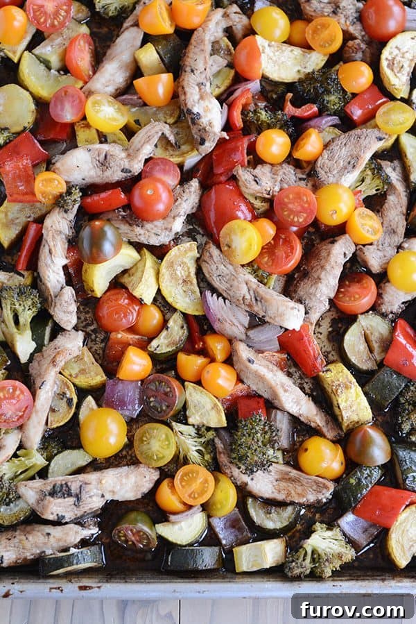 Easy One Pan Balsamic Chicken and Vegetables in 30 Minutes 2 Top view of a pan of cooked chicken and vegetables, showcasing the vibrant colors and glossy balsamic glaze, ready to serve.