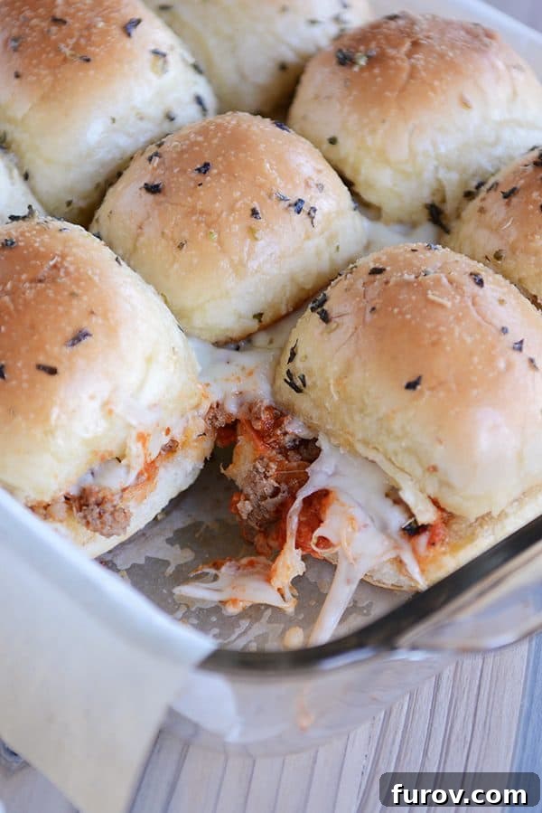 A tray of golden-brown, cheesy pepperoni pull-apart pizza sliders, ready to be served.