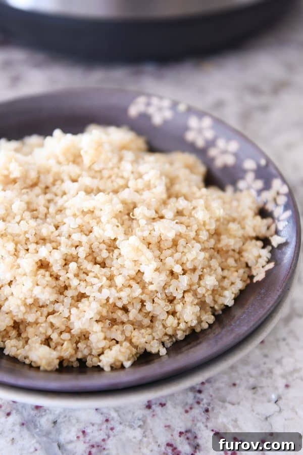 Brown bowl of fluffy cooked quinoa.