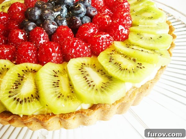 Elegant Fresh Fruit Tart 3 A beautifully decorated fruit tart with a glossy glaze, ready to be served.