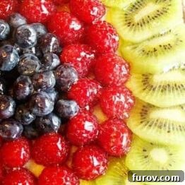 A close-up of a classic fresh fruit tart recipe image.