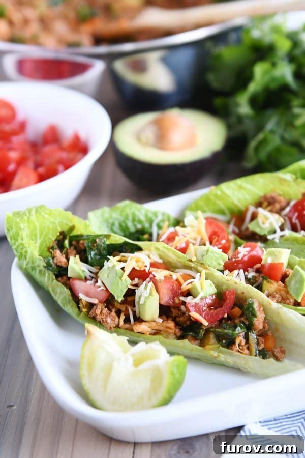 Vibrant Veggie Turkey Lettuce Tacos 2 Freshly prepared veggie turkey taco lettuce wraps on a white serving tray, ready to eat.