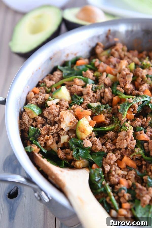 Vibrant Veggie Turkey Lettuce Tacos 3 A large skillet filled with the simmering veggie turkey taco mixture, showcasing the rich colors of the meat and vegetables.