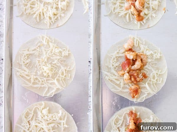 Golden Crunch Shrimp Tacos 7 Flour tortillas arranged on a sheet pan, topped with grated cheese and a savory shrimp mixture, ready for baking into crispy tacos.