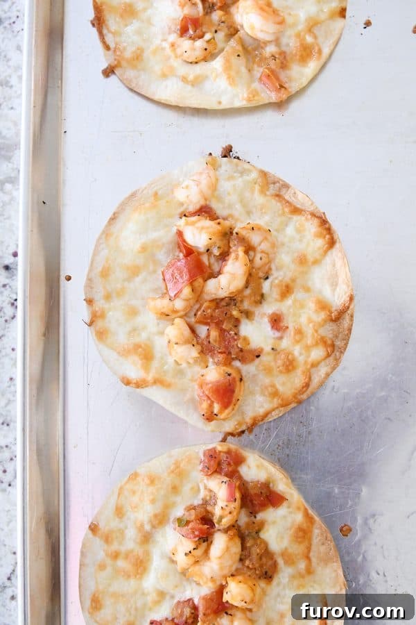 Golden Crunch Shrimp Tacos 8 A sheet pan filled with freshly baked, golden-brown shrimp tacos, their edges perfectly crispy and cheese visibly melted and bubbly.
