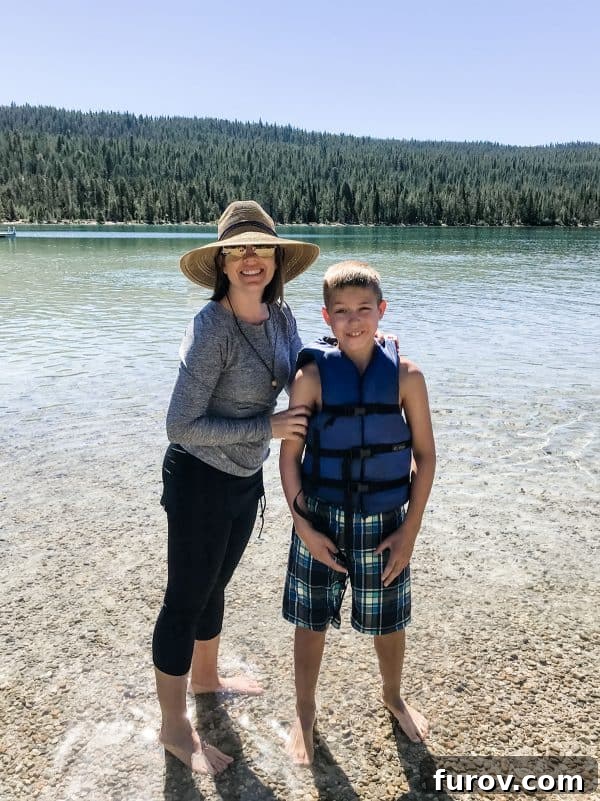 mom and son standing in water at redfish lake