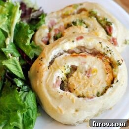 A beautifully baked savory spiral roll, showcasing its golden crust and delicious filling.