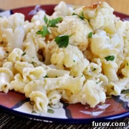 Close-up of roasted garlic and cauliflower pasta on a plate.