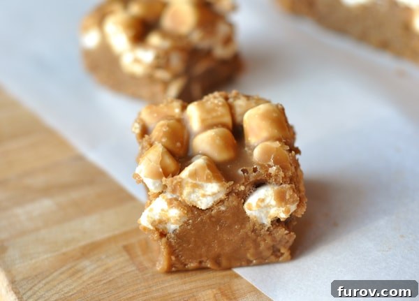 Two squares of creamy Root Beer Float Fudge, adorned with soft mini marshmallows, presented from a top-down view.