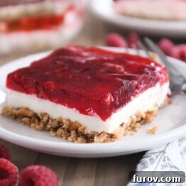 square of raspberry pretzel jello on white plate