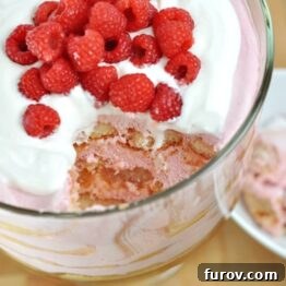 A small image of the Berrymisu Trifle, topped with whipped cream and fresh raspberries.