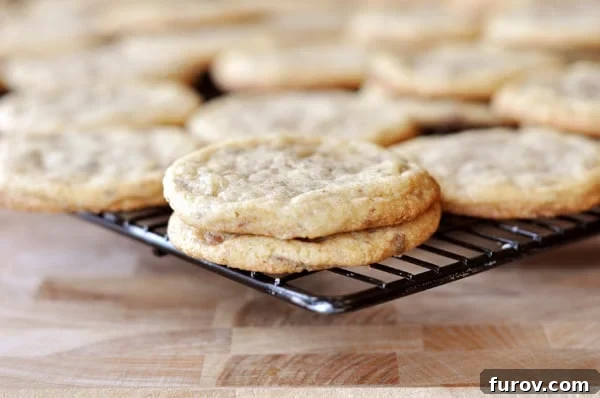 Chocolate Toffee Crunch Cookies 3 Cookies on a dark cooling rack.