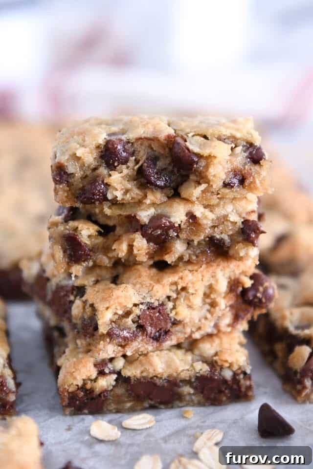 Homestyle Oatmeal Chocolate Chip Cookie Bars 9 Several stacked oatmeal chocolate chip cookie bars, showing their thick, soft centers and abundant chocolate chips.
