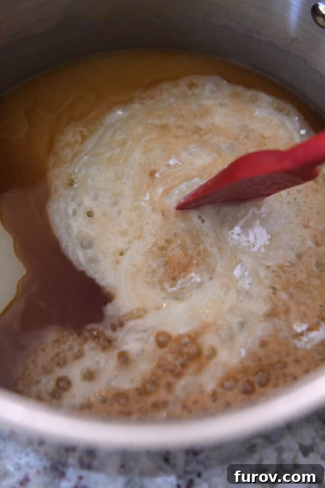 Velvety Buttermilk Caramel 5 Stirring vanilla and baking soda into syrup in saucepan.