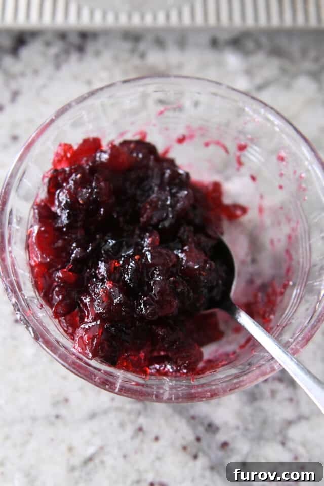 Sweet & Savory Brie Cranberry Puffs 4 Cranberry sauce in small glass bowl.
