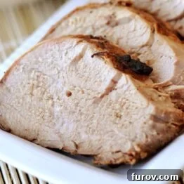 Sliced pork tenderloin on a white platter