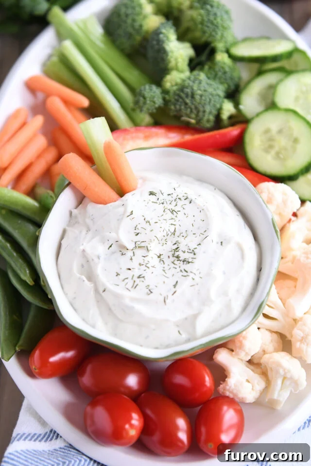 Two vibrant carrot sticks and a crisp piece of celery artfully arranged in a small bowl, ready to be dipped into the creamy, flavorful veggie dip.