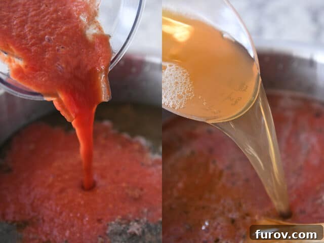 Hands pouring crushed tomatoes and rich broth into a large soup pot with browned beef and onions, creating the base of a creamy tomato noodle soup.