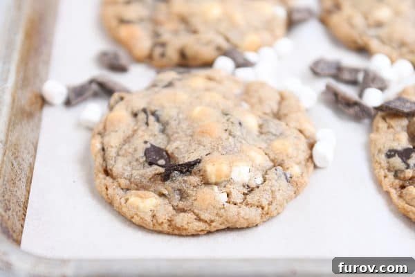 Girls' Camp Food Planning: Menus, Tips and Resources for Large Groups 4 S'Mores chocolate chip cookie on parchment lined baking tray.