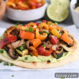 Creamy Avocado & Roasted Garden Flatbread 9 Flatbread topped with creamy avocado sauce and roasted vegetables.