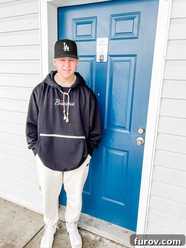 College kid standing outside apartment.