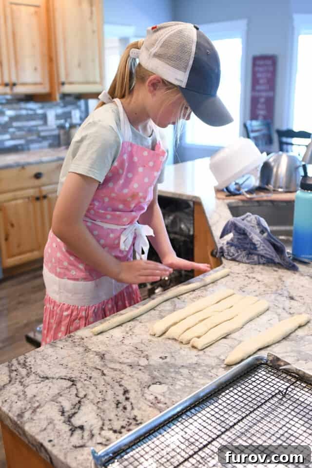 Young girl making pretzels.