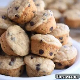 Stack of mini banana chocolate chip muffins on white plate, ready to be enjoyed.