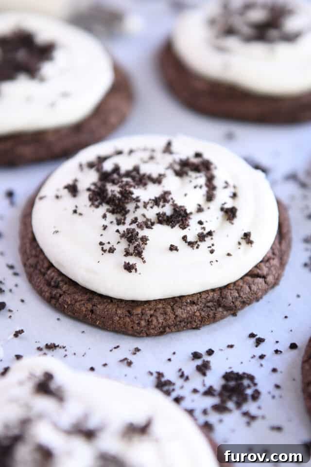 Decadent Chocolate Oreo cookie with smooth white frosting and scattered Oreo crumbs, ready to be enjoyed.