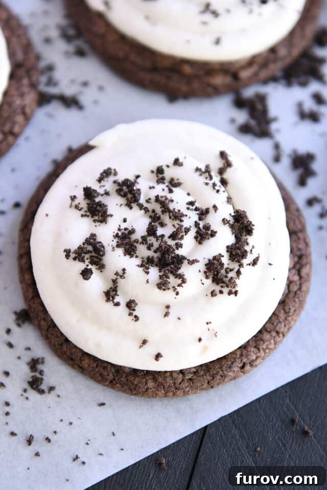 Overhead view of a beautifully frosted Chocolate Oreo cookie, adorned with crushed Oreo crumbs.