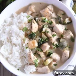 Top down view of chicken and zucchini in cream sauce over white rice. A vibrant overhead shot of the delicious Coconut Lime Chicken and Zucchini.